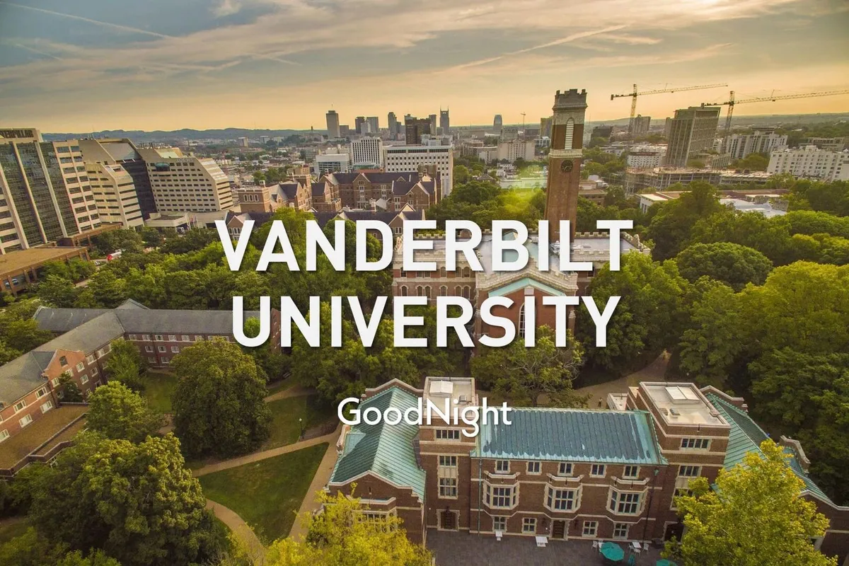 A wide view of Vanderbilt University’s iconic clock tower rising above campus buildings, with the city skyline visible in the background. The scene is bathed in sunlight, evoking a sense of place and proximity to major business centers.