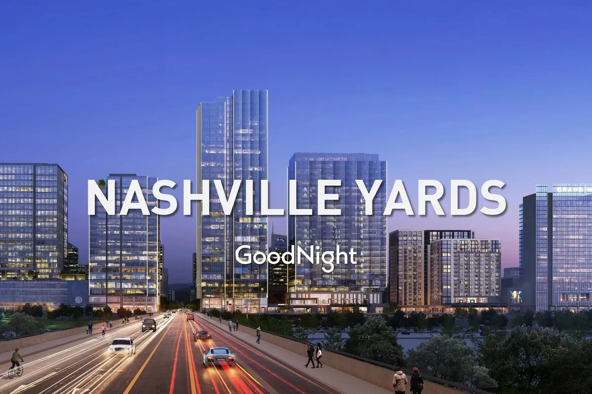 A vibrant city exterior with skyscrapers, a bustling road, and the energetic Nashville skyline. The lively atmosphere hints at nightlife and dining destinations within easy reach.