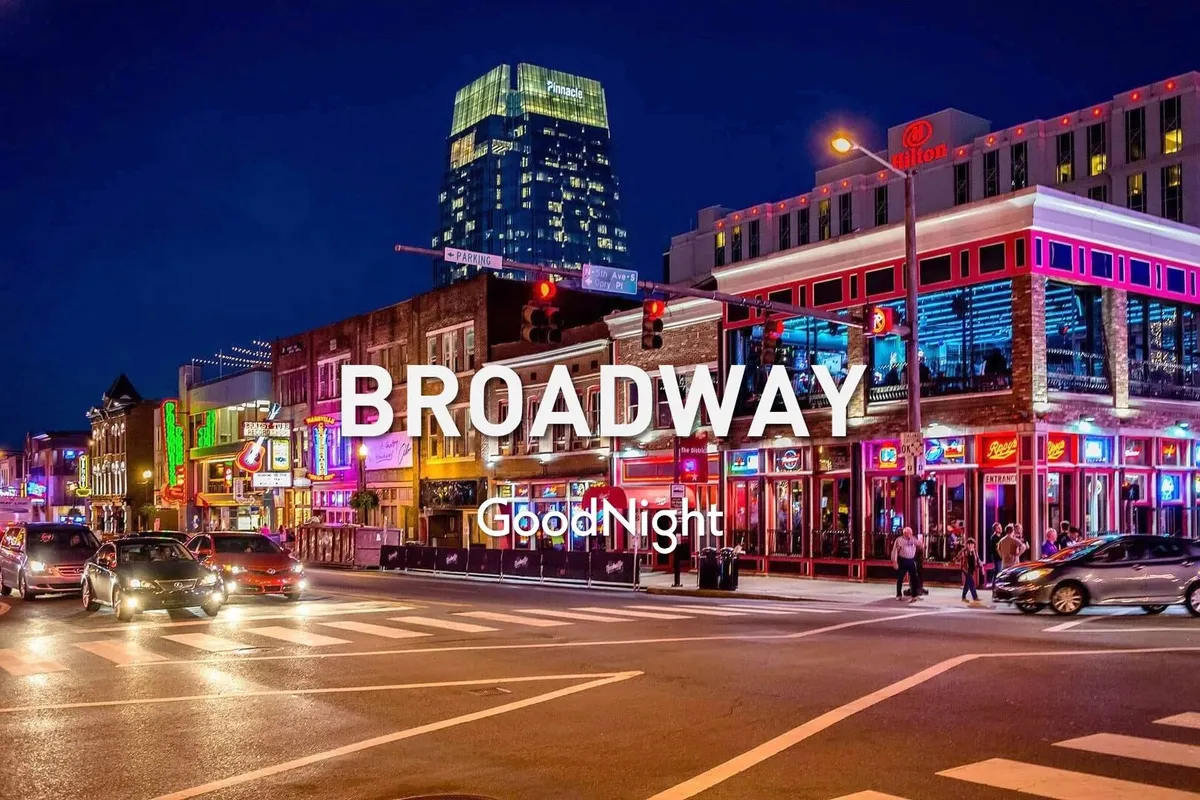 This energetic exterior shot captures Nashville’s bustling nightlife on Broadway, with neon signs illuminating a busy street filled with pedestrians, high-rise buildings, and a sense of lively movement. The scene radiates the vibrant energy and cultural excitement that make the city famous for live music and entertainment.